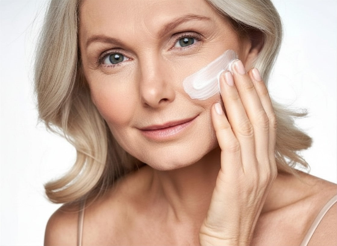 Woman applying Au Natural face cream for aging skin to her face.